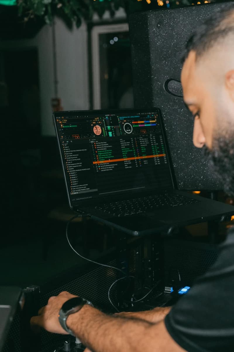 DJ laptop running Serato beside the decks