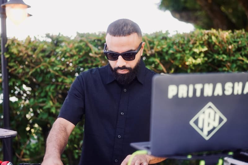 Prit Nasha DJing outdoors at a daytime wedding celebration