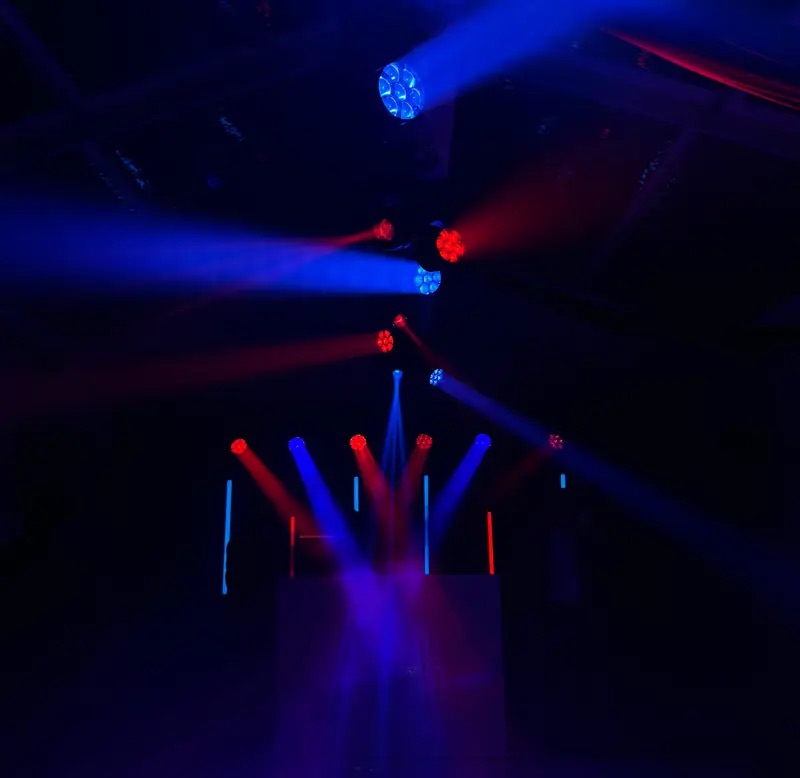 Moving-head beams crossing a dark room