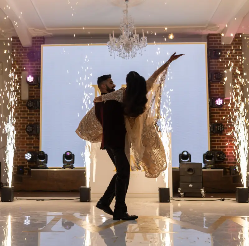 A couple’s first dance between two fountains of cold sparks