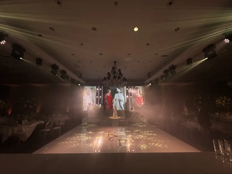 Low fog across a lit dancefloor in front of an LED wall